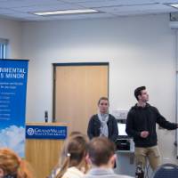 A group of students present their sustainability project while reference a power point.